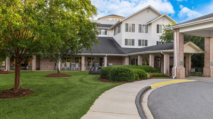 A welcoming entrance surrounded by vibrant greenery, inviting residents to connect and thrive.