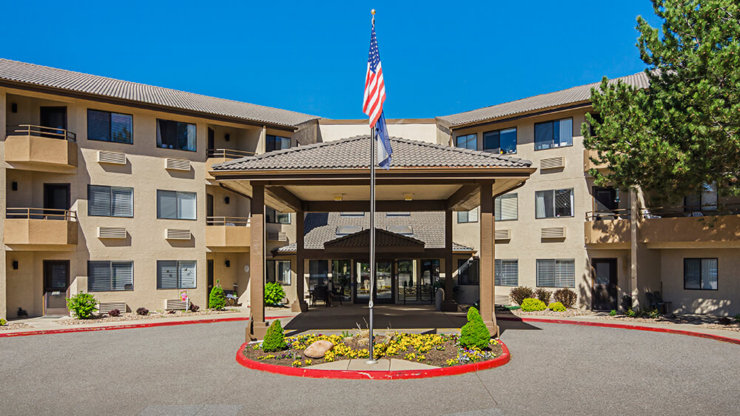 A welcoming entrance surrounded by greenery and bright skies, perfect for a warm community atmosphere.