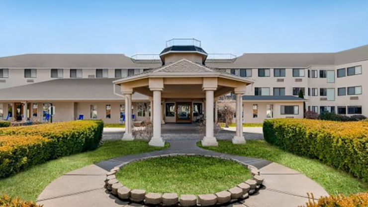 A welcoming entrance surrounded by vibrant greenery, inviting residents into a nurturing community atmosphere.