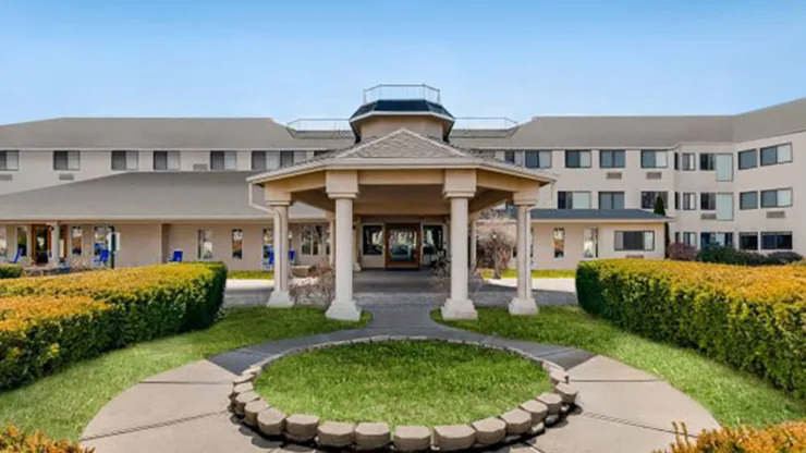 A welcoming entrance surrounded by vibrant greenery, inviting residents into a nurturing community atmosphere.