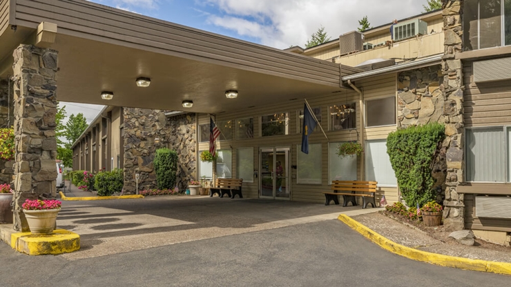 Welcoming entrance with lush plants and cozy seating, inviting a sense of community and warmth.