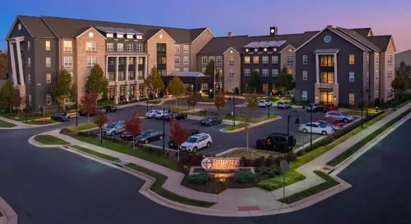 Welcoming community ambiance with beautiful architecture and lush surroundings, promoting comfort and connection.