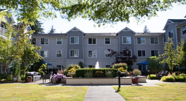 Serene outdoor space with vibrant gardens and welcoming architecture, perfect for community gatherings.