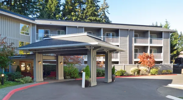 Welcoming entrance surrounded by lush greenery, inviting residents to enjoy a vibrant community.
