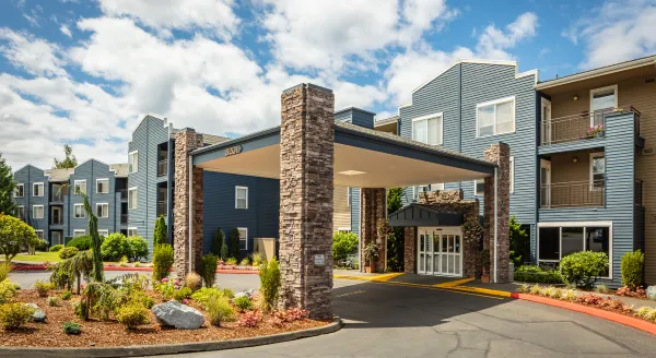 Welcoming entrance surrounded by lush greenery, inviting a sense of community and comfort for all.