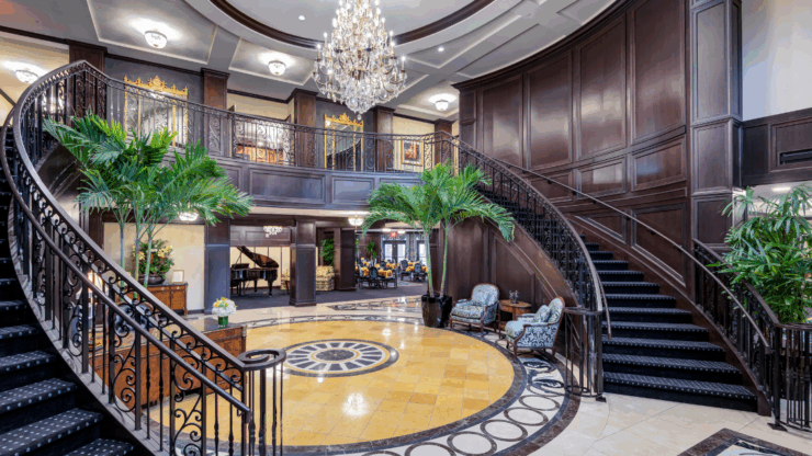 An inviting lobby features elegant decor, lush plants, and cozy seating, fostering warmth and community.