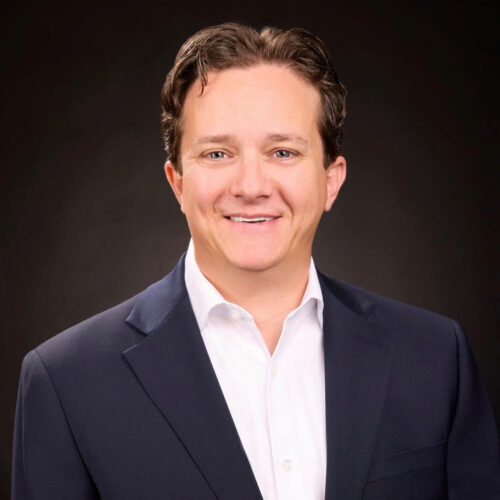 A welcoming smile conveys warmth and professionalism, reflecting a supportive community atmosphere.