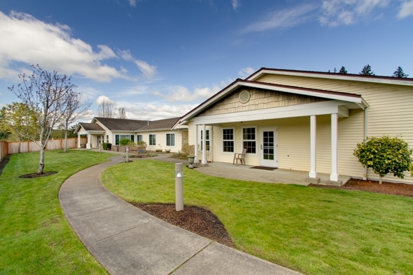 A welcoming, well-maintained pathway leads through a lush green lawn, inviting community and friendship.