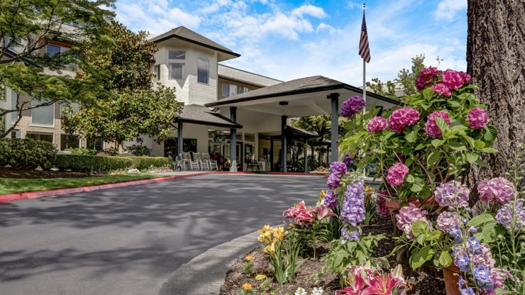 A welcoming entrance adorned with vibrant flowers and gentle greenery, inviting a sense of community and warmth.