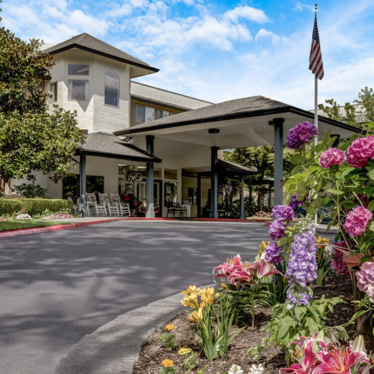 A welcoming entrance adorned with vibrant flowers and gentle greenery, inviting a sense of community and warmth.