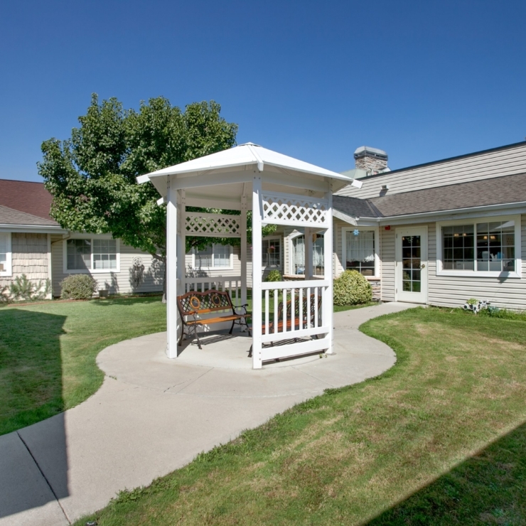 A welcoming gazebo surrounded by lush greenery invites residents to relax and connect.