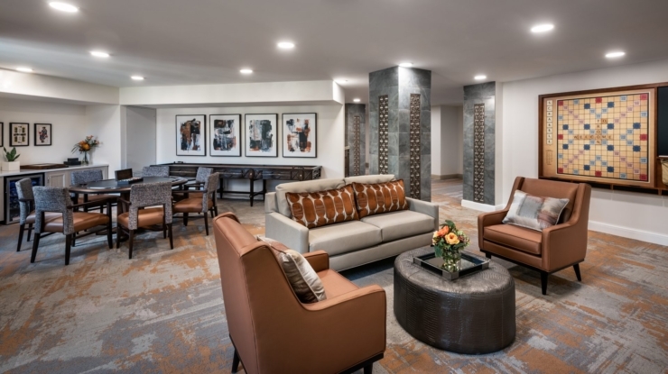 A welcoming lounge with comfortable seating, vibrant art, and inviting spaces for community connection.