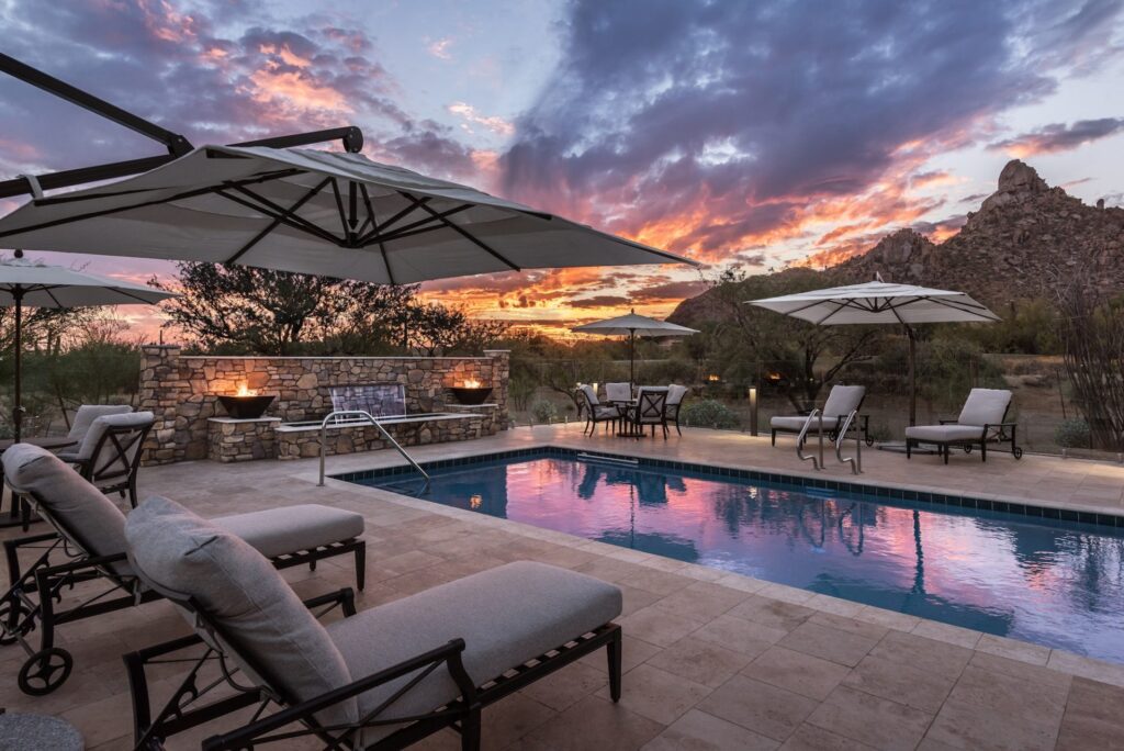 Relaxation and tranquility poolside, surrounded by serene nature and a stunning sunset.
