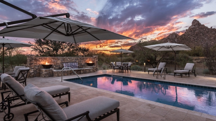 Relaxation and tranquility poolside, surrounded by serene nature and a stunning sunset.