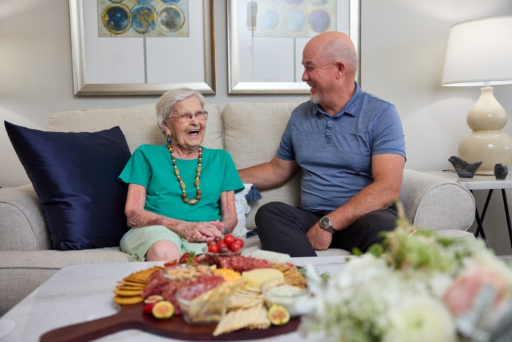 A joyful moment shared between a resident and a visitor, radiating warmth and community spirit.