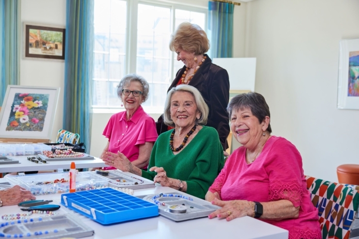 A vibrant gathering of friends engaged in creative activities, showcasing joy and connection in a welcoming space.