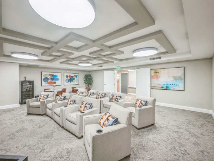 A welcoming lounge featuring modern seating, vibrant artwork, and a warm atmosphere for community gatherings.
