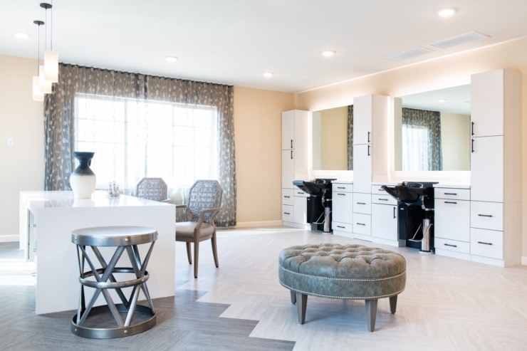 Bright and airy salon space inviting relaxation and social interaction, with comfortable seating and elegant decor.
