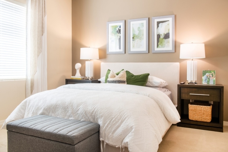 A cozy bedroom filled with warmth, featuring soft bedding, inviting decor, and natural light.