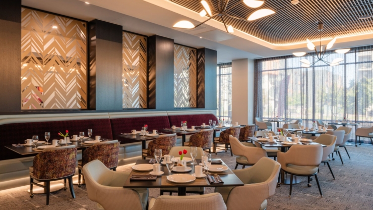 A vibrant dining area filled with light, welcoming decor, perfect for community gatherings and conversation.