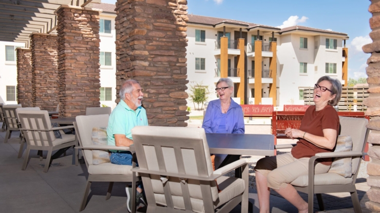 Seniors share laughter and warmth in a welcoming outdoor space, embracing community and joy.