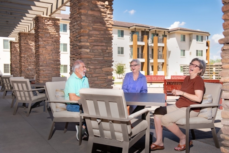 Seniors share laughter and warmth in a welcoming outdoor space, embracing community and joy.