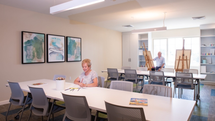 Bright, welcoming art space buzzing with creativity and connection among residents.