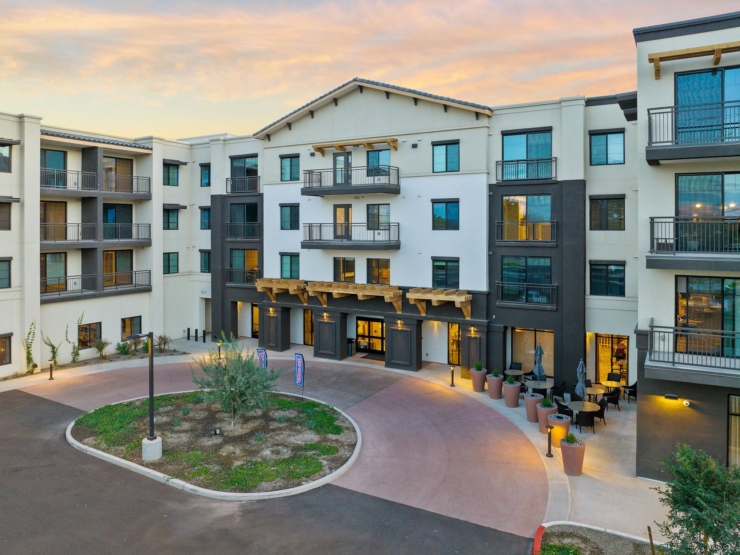 A welcoming courtyard surrounded by contemporary architecture invites a sense of community and comfort.