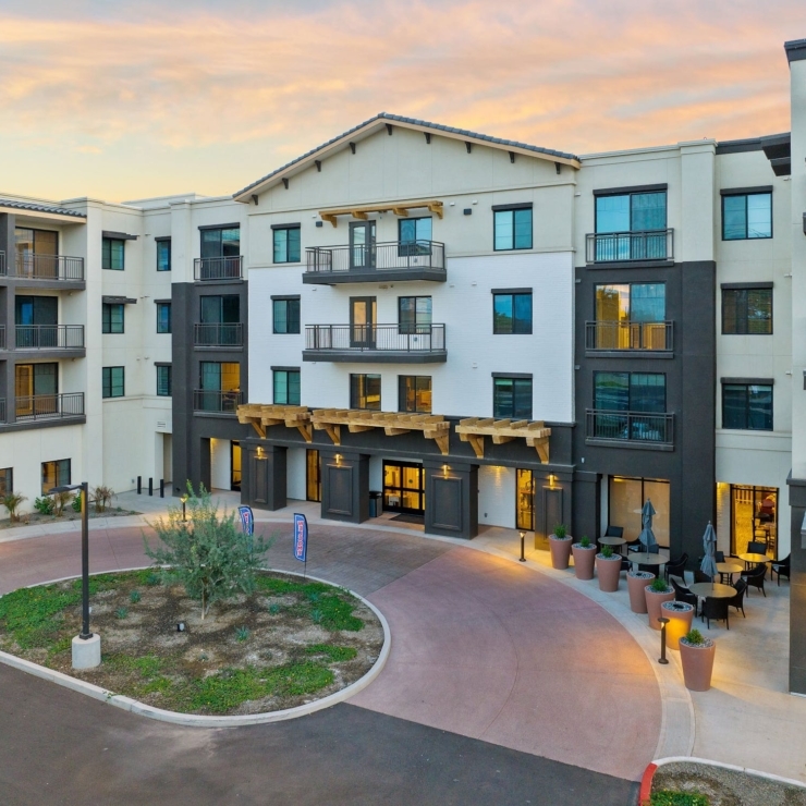 A welcoming courtyard surrounded by contemporary architecture invites a sense of community and comfort.