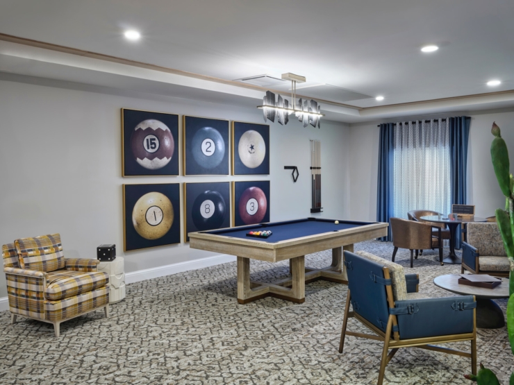 An inviting game room adorned with a billiards table and comfortable seating, fostering community joy.