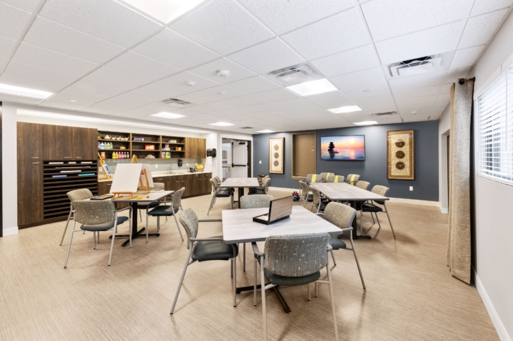 A welcoming activity space filled with light, encouraging community and creativity among residents.
