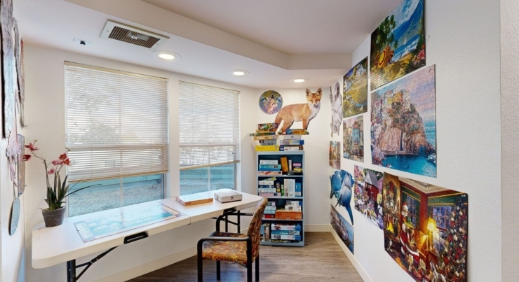 A bright, inviting space filled with colorful puzzles and art, perfect for community gatherings and relaxation.