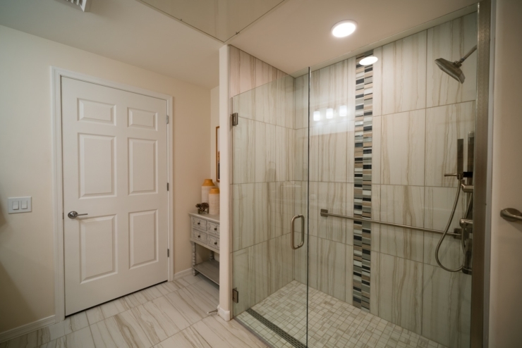 An inviting, modern bathroom featuring a spacious walk-in shower and elegant design, promoting comfort.