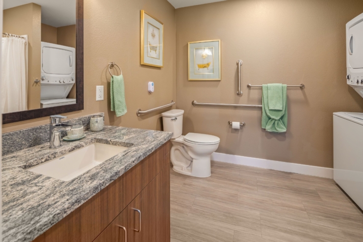 A bright, welcoming bathroom featuring modern amenities, ensuring comfort and accessibility for all residents.