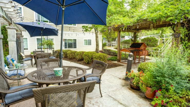 A cozy outdoor space featuring inviting seating, lush greenery, and warm ambiance for gatherings.