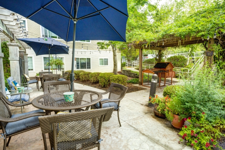A cozy outdoor space featuring inviting seating, lush greenery, and warm ambiance for gatherings.