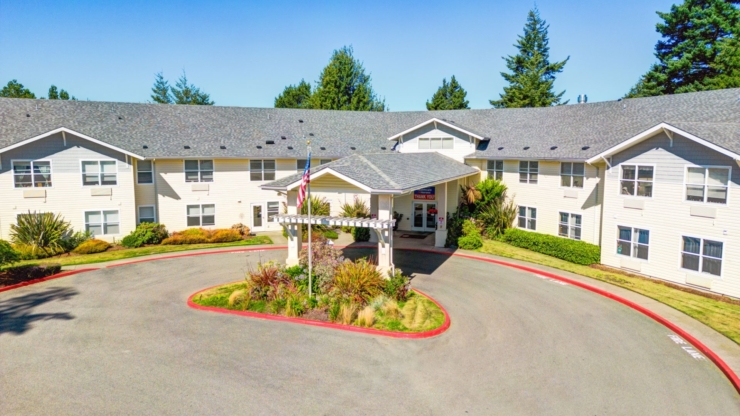 A welcoming entrance surrounded by lush greenery, creating a warm community atmosphere.