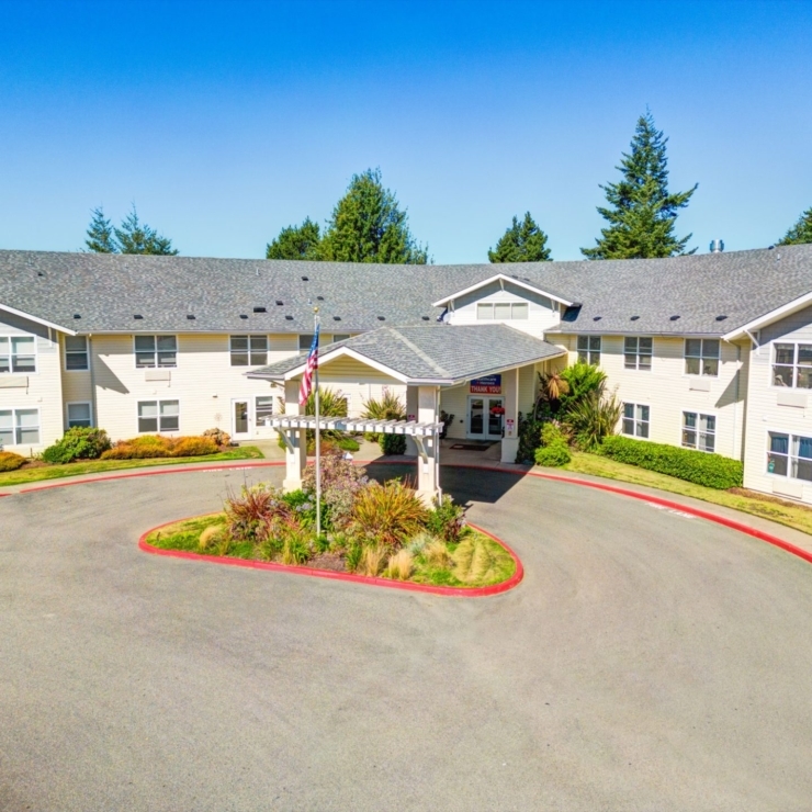 A welcoming entrance surrounded by lush greenery, creating a warm community atmosphere.