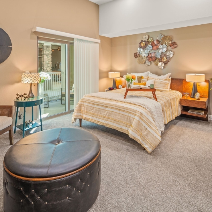 A warm, inviting room featuring a comfortable bed, cozy seating, and vibrant decor, perfect for relaxation.