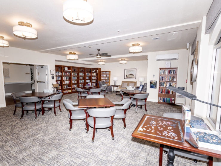 A welcoming communal space filled with cozy seating, bookshelves, and warm lighting, perfect for gathering.