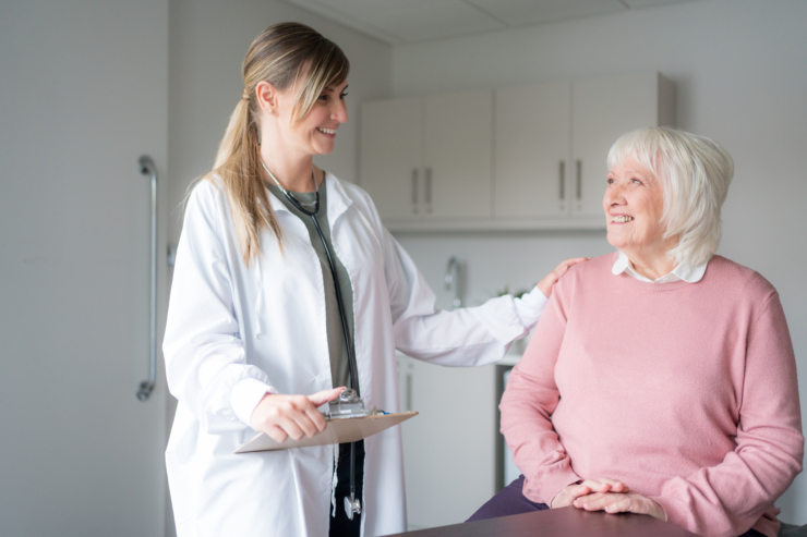 A warm interaction between a caregiver and resident, showcasing genuine care and community spirit.