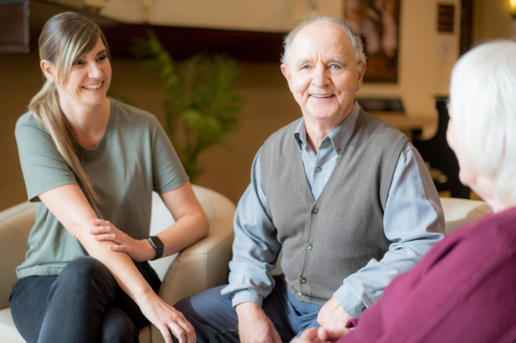 A warm conversation unfolds in a welcoming lounge, fostering community and connection among residents.