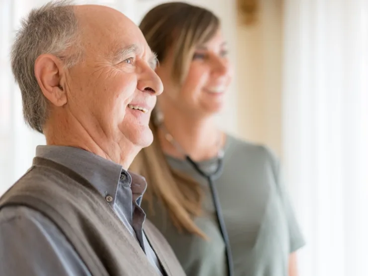A warm moment shared between a resident and caregiver, highlighting community and care in a cozy setting.