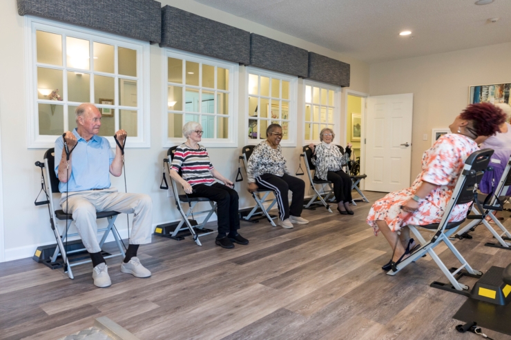 Engaged residents enjoy a lively fitness class, fostering connection and well-being in a welcoming space.