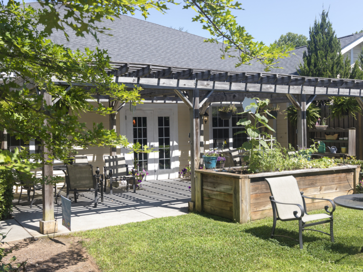 A welcoming garden space with shaded seating invites relaxation and community connection.