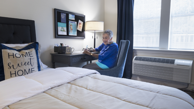 A cozy room filled with warmth, showcasing a resident joyfully engaging in creative activities.