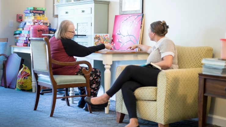 A warm, inviting space where residents connect over art, fostering community and companionship.