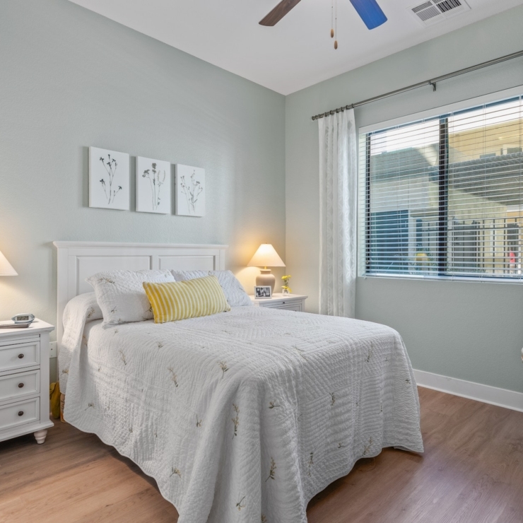 A serene bedroom with soft colors, inviting decor, and natural light, perfect for relaxation and community.