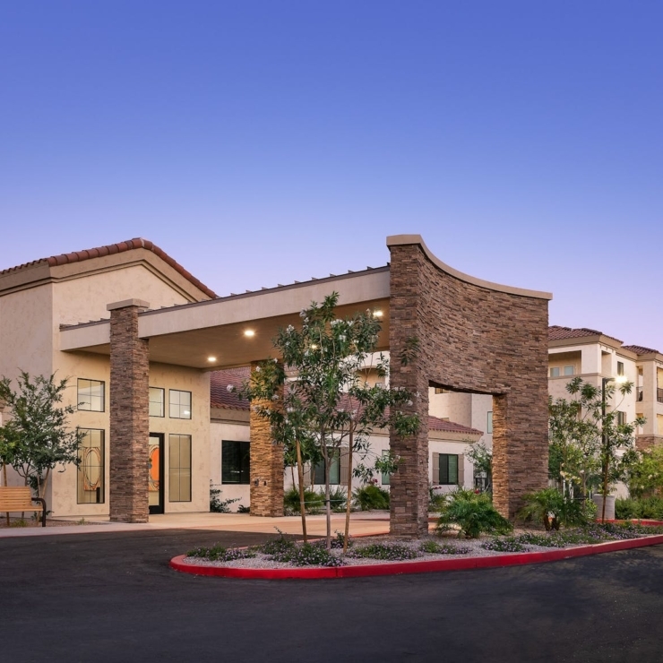 A welcoming entrance surrounded by greenery, inviting residents to a warm, supportive community.