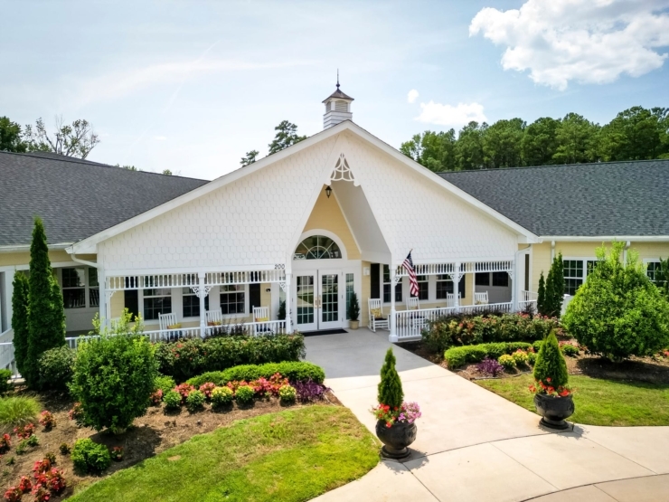A welcoming entrance surrounded by vibrant gardens invites connection and community.